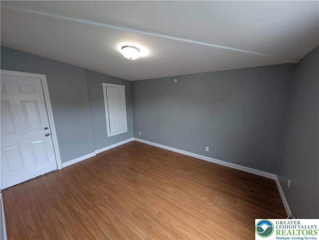 1027 Walnut Street, Unit 3 Allentown, PA 18102 - Photo 7 of 14 a view of an empty room with wooden floor