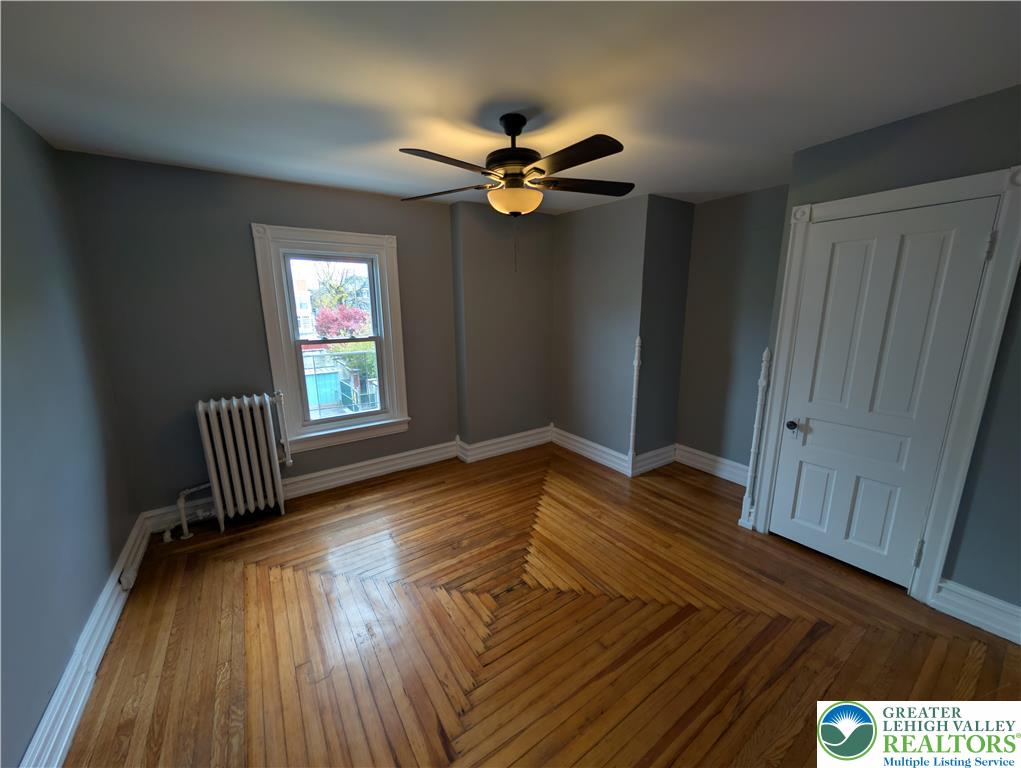 1027 Walnut Street, Unit 3 Allentown, PA 18102 - Photo 9 of 14 wooden floor in an empty room with a window