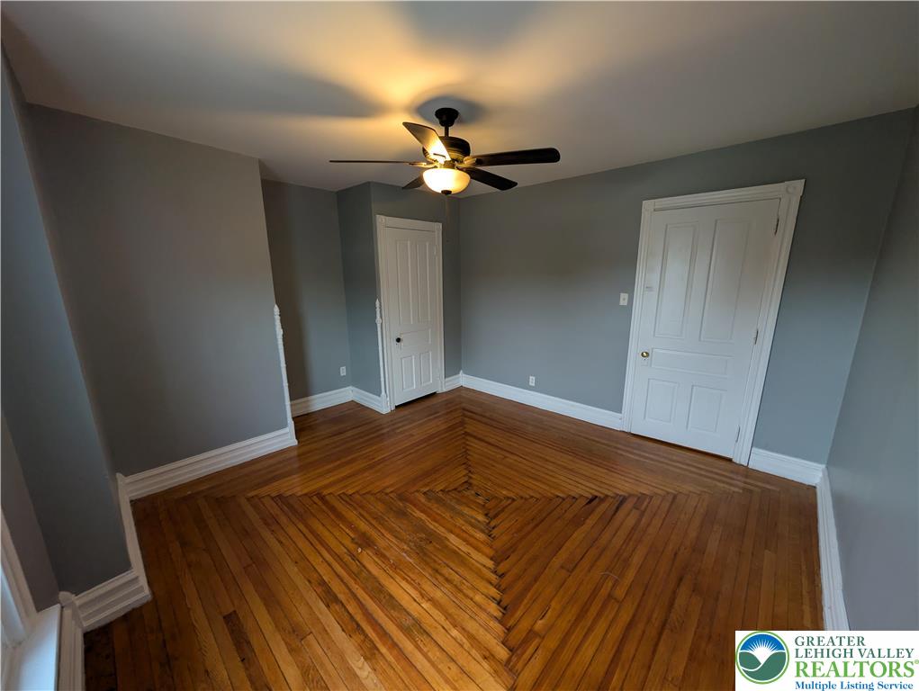 1027 Walnut Street, Unit 3 Allentown, PA 18102 - Photo 10 of 14 a bedroom with a bed and a chandelier