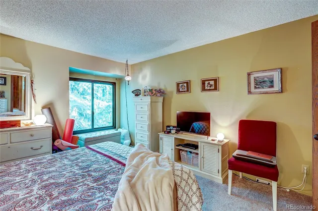 a bedroom with a bed and a chair