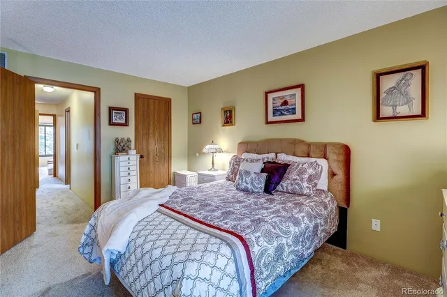 a bedroom with a large bed and a chandelier
