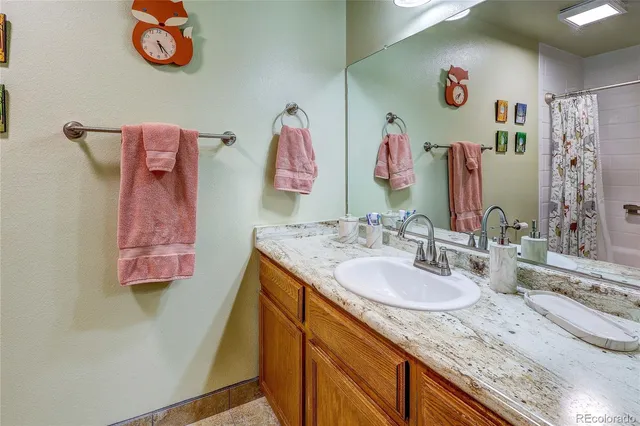 a bathroom with a sink mirror and vanity