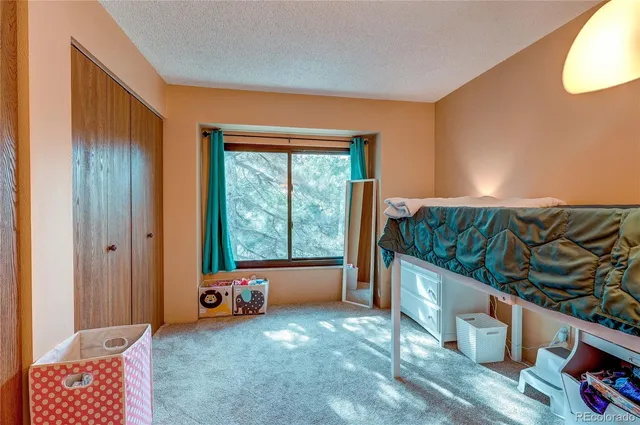 a bedroom with furniture and a window