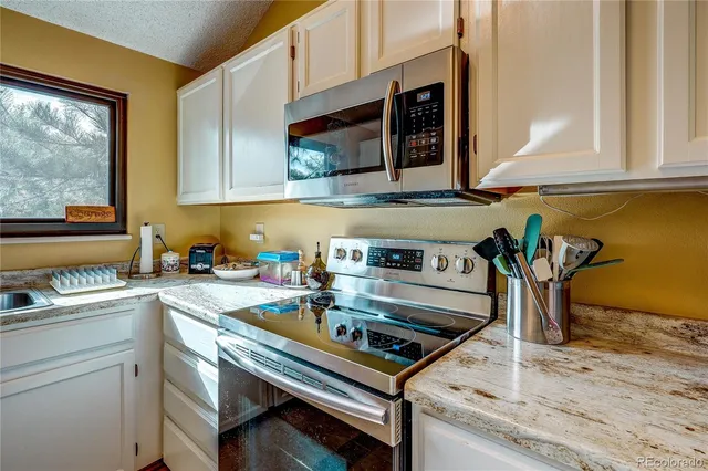 a kitchen with a stove and a sink