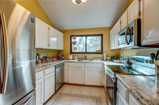 a kitchen with a sink stove and cabinets