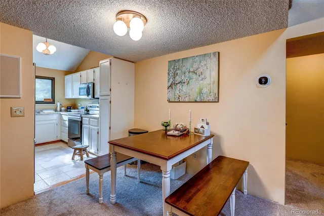 a kitchen with a refrigerator and a stove top oven