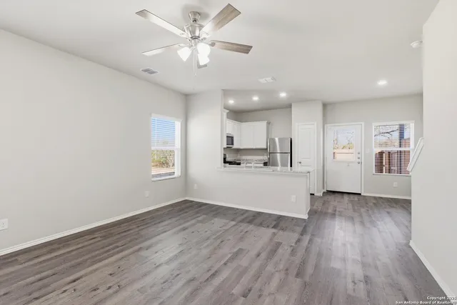 a view of a kitchen with a dishwasher cabinets and wooden floor