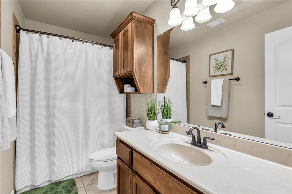 910 Springdale Lane Lorena, TX 76655 - Photo 26 of 39 Bathroom featuring a vanity with a light-colored countertop, an integrated sink, and a dark bronze faucet