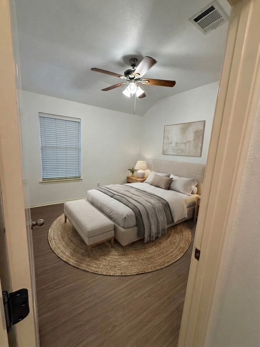 2122 Rachel Lane Round Rock, TX 78664 - Photo 12 of 15 a bedroom with a bed and a chandelier