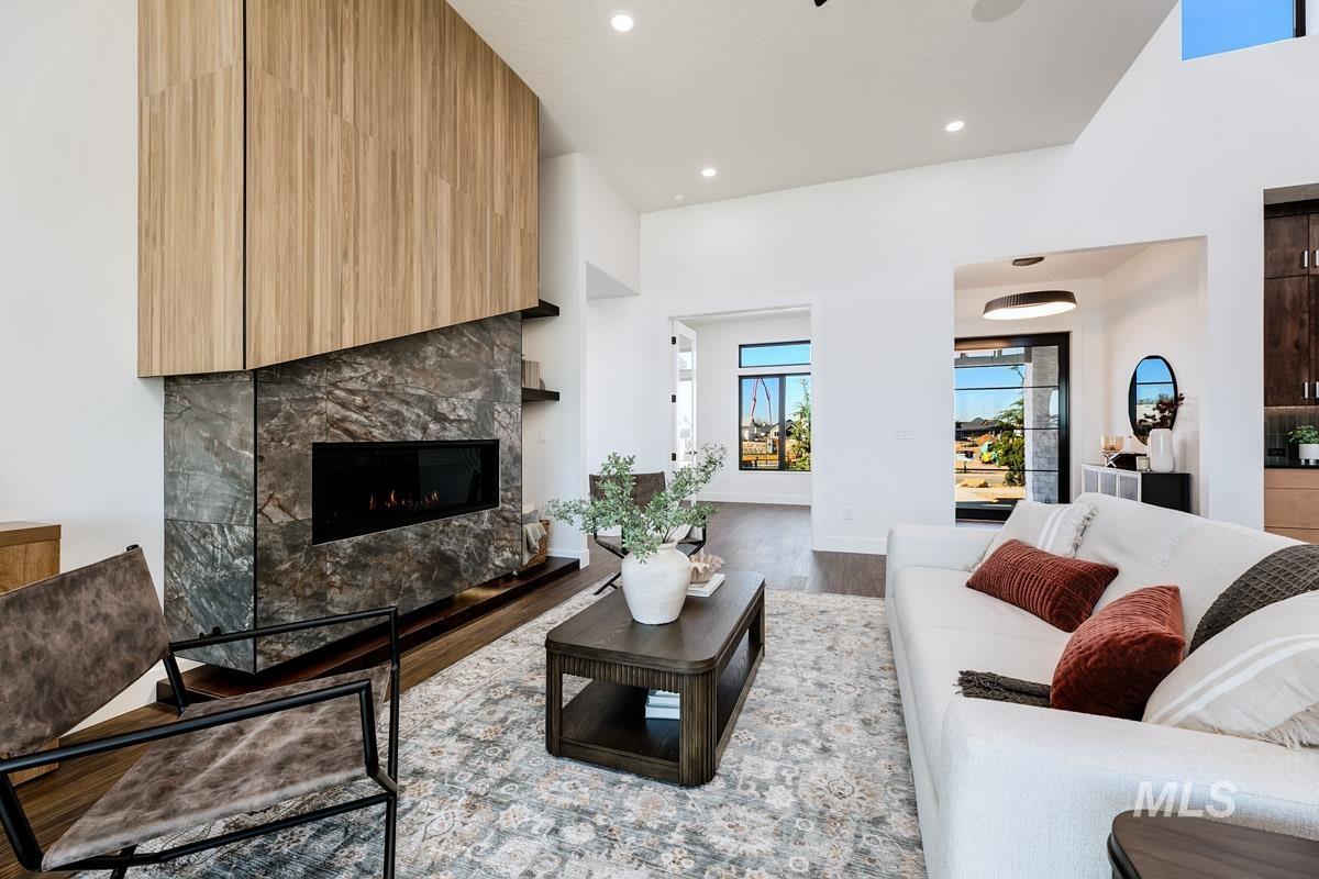 525 Founder Avenue Middleton, ID 83644 - Photo 12 of 50 Living area with wood finished floors, a high ceiling, a high end fireplace, and recessed lighting