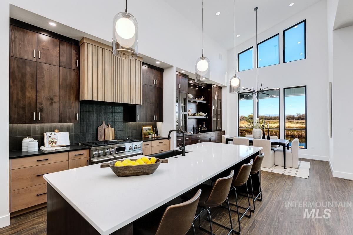 525 Founder Avenue Middleton, ID 83644 - Photo 19 of 50 Dual tone kitchen featuring dark wood-style floors, modern cabinets, extractor fan, double oven range, and a large island