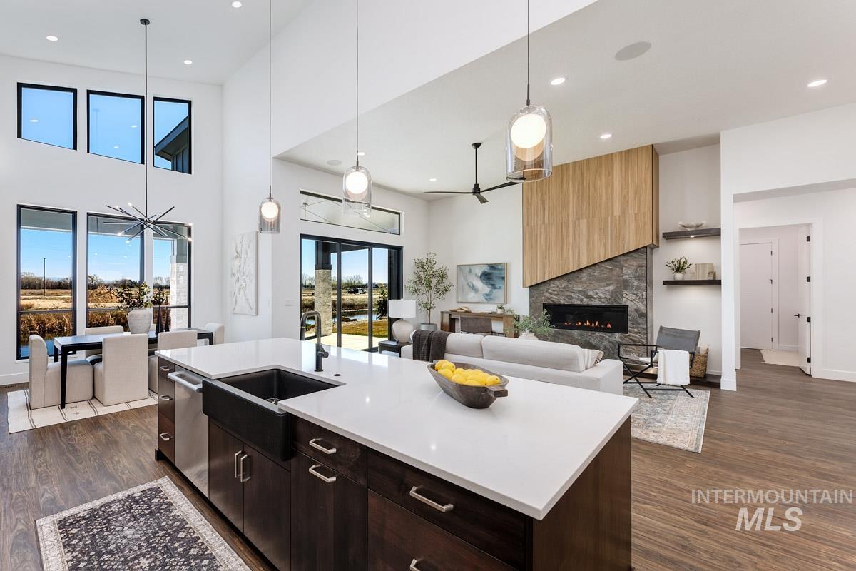 525 Founder Avenue Middleton, ID 83644 - Photo 50 of 50 Kitchen with open floor plan, a kitchen island with sink, dark wood-style floors, a high ceiling, and dark wood finish cabinets