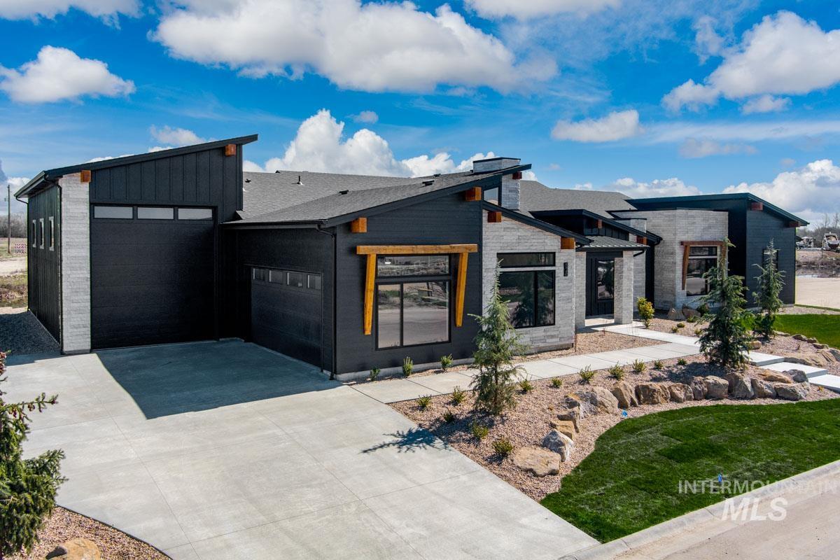 525 Founder Avenue Middleton, ID 83644 - Photo 2 of 50 Modern home featuring driveway, an attached garage, board and batten siding, and stone siding