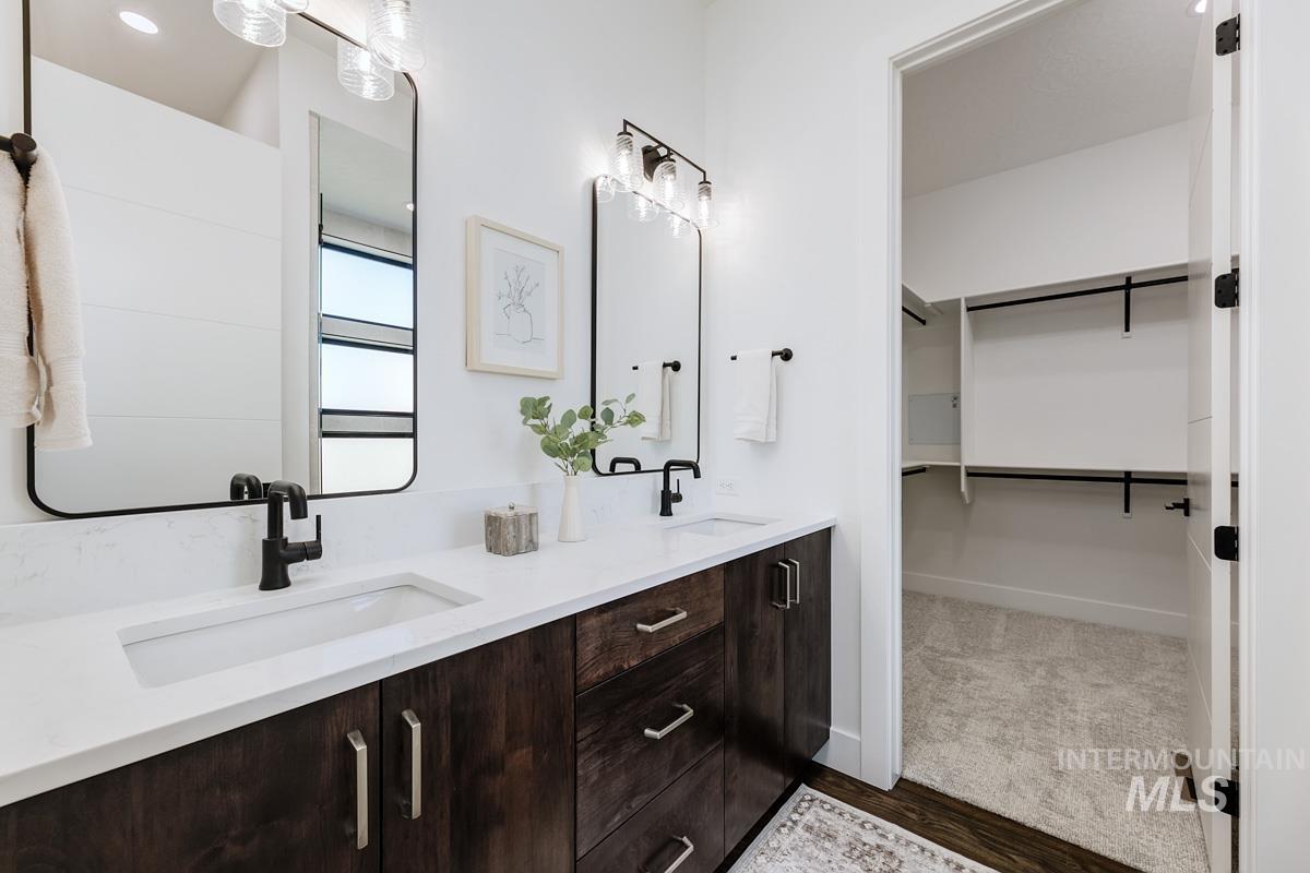 525 Founder Avenue Middleton, ID 83644 - Photo 34 of 50 Full bathroom featuring double vanity, dark wood finished floors, and a spacious closet