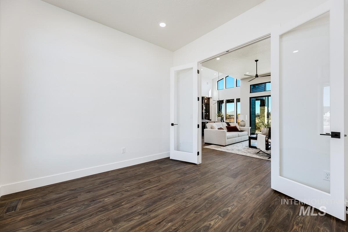 525 Founder Avenue Middleton, ID 83644 - Photo 37 of 50 Unfurnished room featuring dark wood finished floors, french doors, recessed lighting, ceiling fan, and a high ceiling