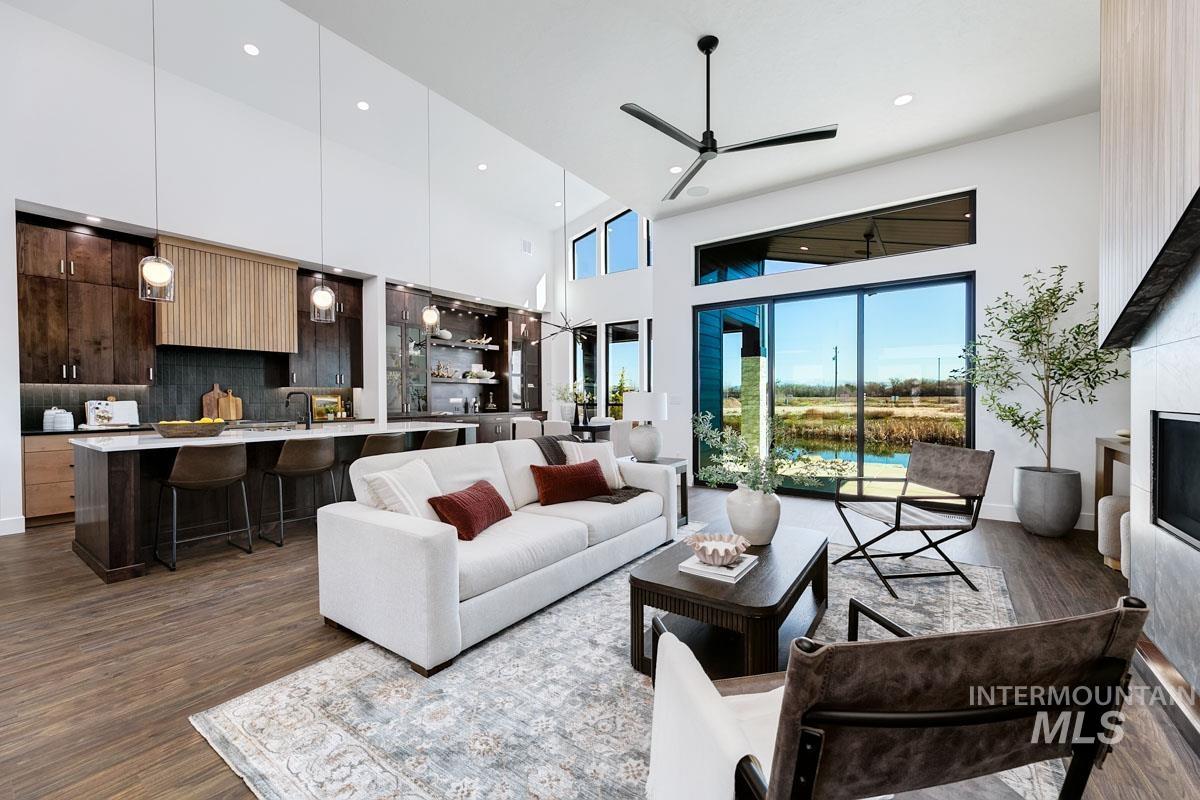 525 Founder Avenue Middleton, ID 83644 - Photo 9 of 50 Living room with a high ceiling, dark wood-style floors, ceiling fan, and recessed lighting