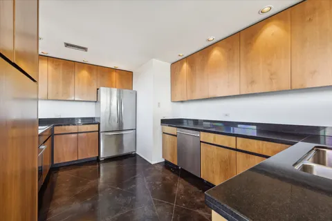 a kitchen with stainless steel appliances a refrigerator sink and microwave