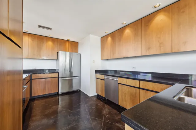 a kitchen with stainless steel appliances a refrigerator sink and microwave