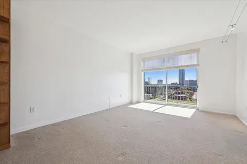 a view of a room with a ceiling fan and window
