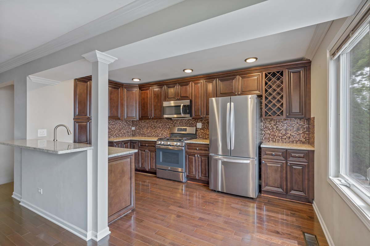 1004 Inverrary Lane Deerfield, IL 60015 - Photo 7 of 19 a kitchen with stainless steel appliances granite countertop a refrigerator and a stove top oven