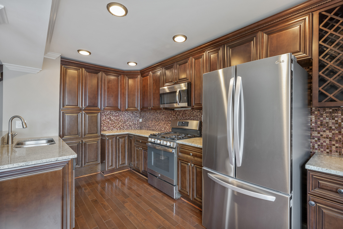 1004 Inverrary Lane Deerfield, IL 60015 - Photo 8 of 19 a kitchen with stainless steel appliances granite countertop a refrigerator stove and sink