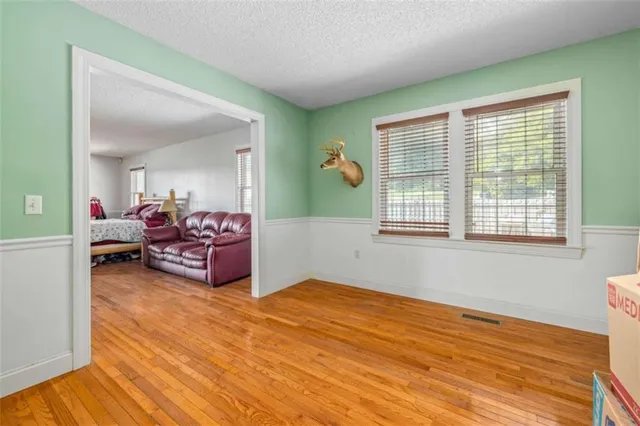 a view of a livingroom with a hardwood floor and a ceiling fan