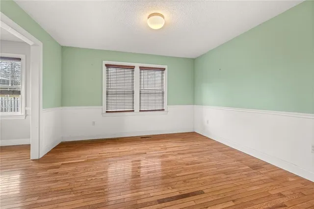 a view of a livingroom with wooden floor and a window