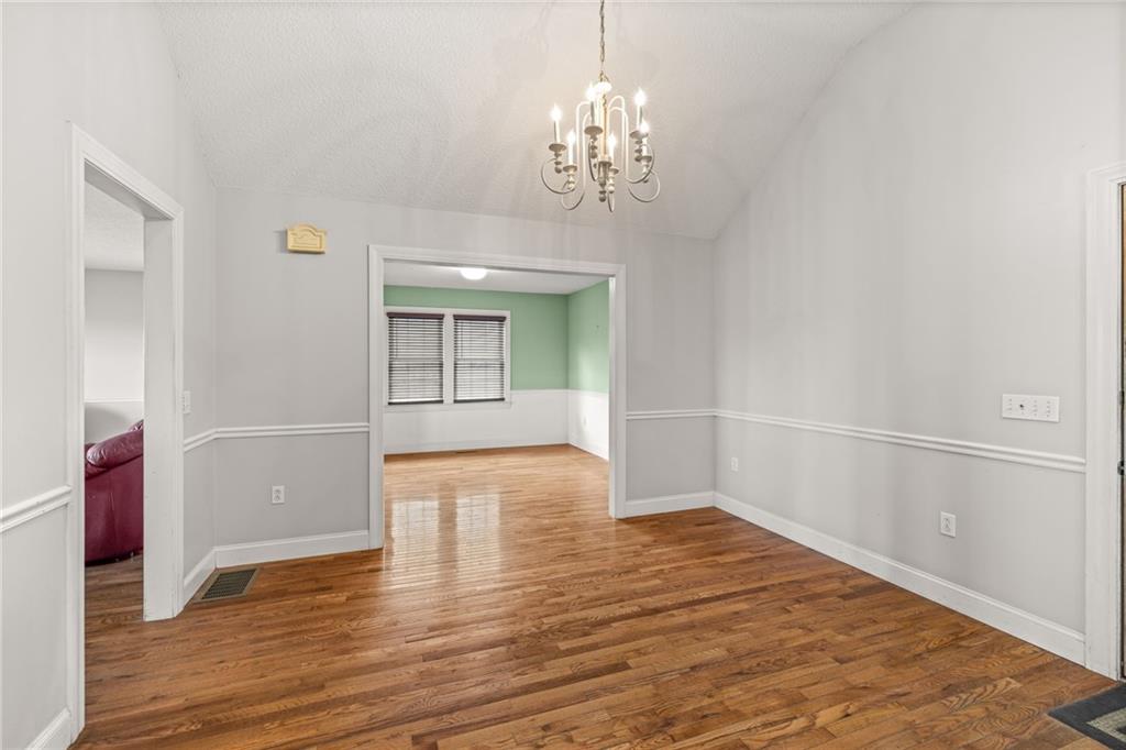 131 Caudell Drive Lula, GA 30554 - Photo 16 of 68 wooden floor in an empty room with a window