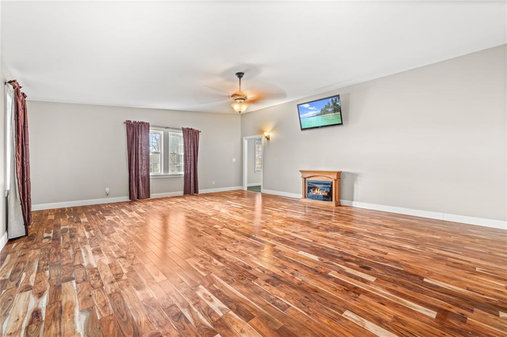 131 Caudell Drive Lula, GA 30554 - Photo 21 of 68 a view of a livingroom with a hardwood floor and a ceiling fan
