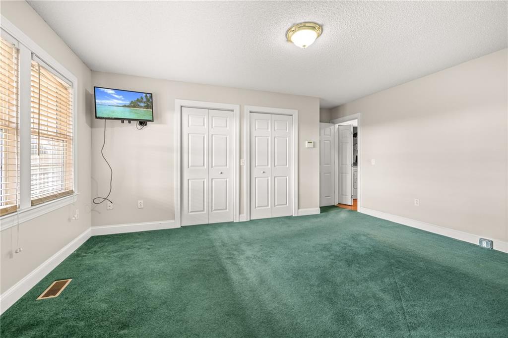131 Caudell Drive Lula, GA 30554 - Photo 23 of 68 a view of a livingroom with wooden floor and a window
