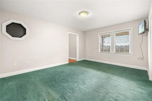 a house view with swimming pool and trees in the background