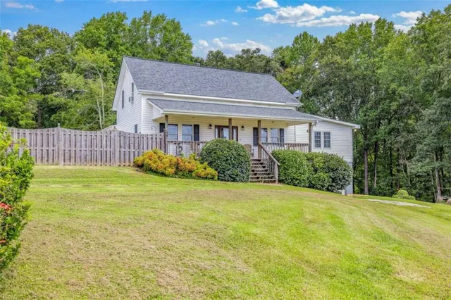 a living room with furniture a ceiling fan and a window