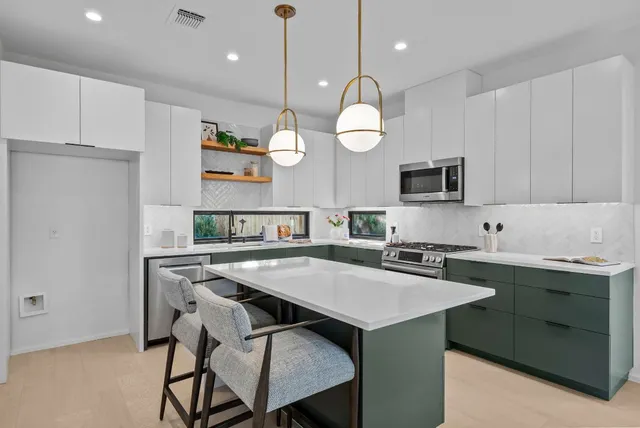 a kitchen with a table chairs sink and cabinets
