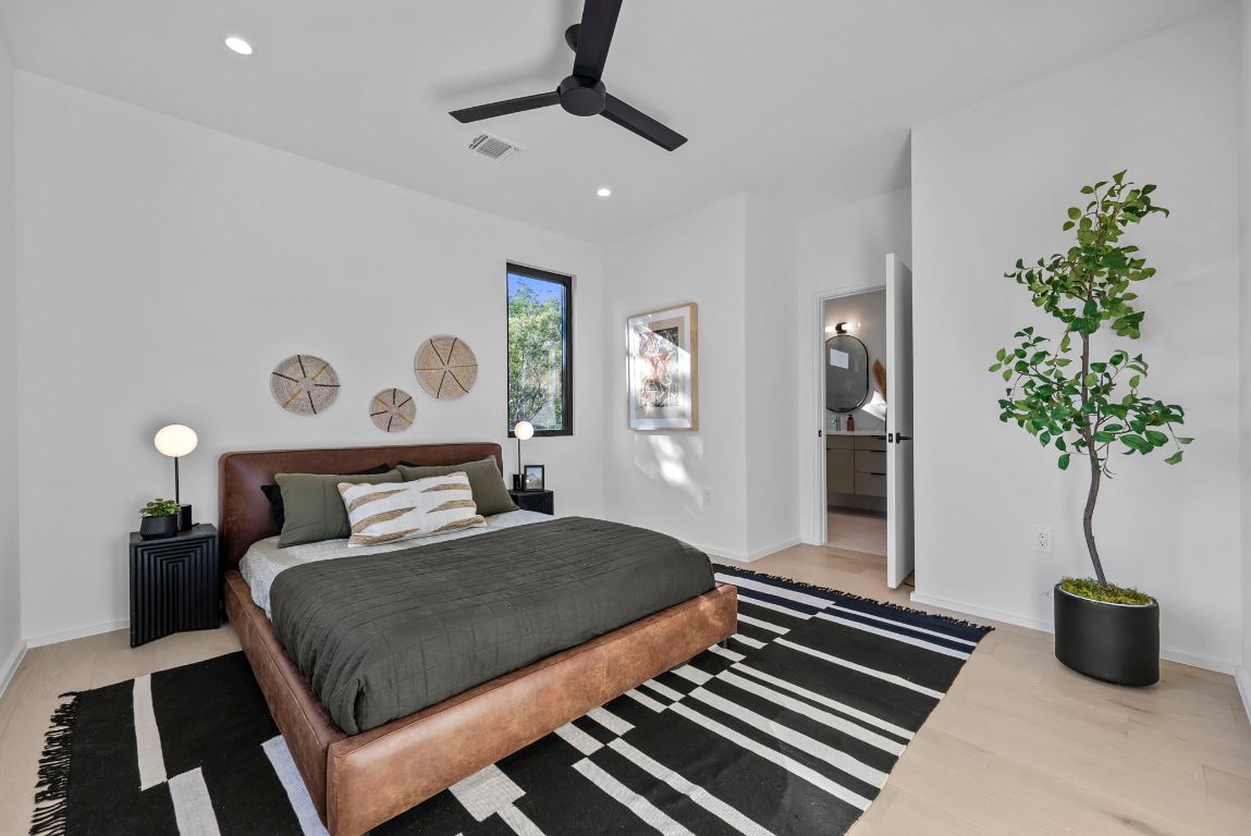 1216 Arcadia Avenue, Unit 2 Austin, TX 78757 - Photo 8 of 14 a bedroom with a large bed and a potted plant