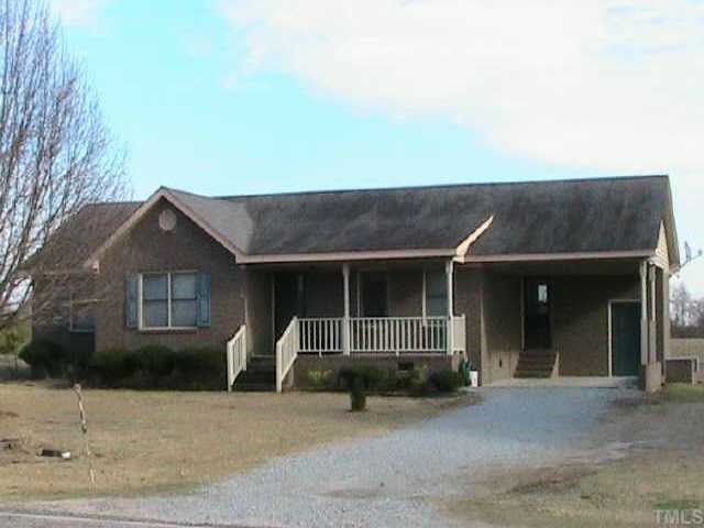 652 Old Stage Road North Coats, NC 27521 - Photo 1 of 10 front view of a house with potted plants
