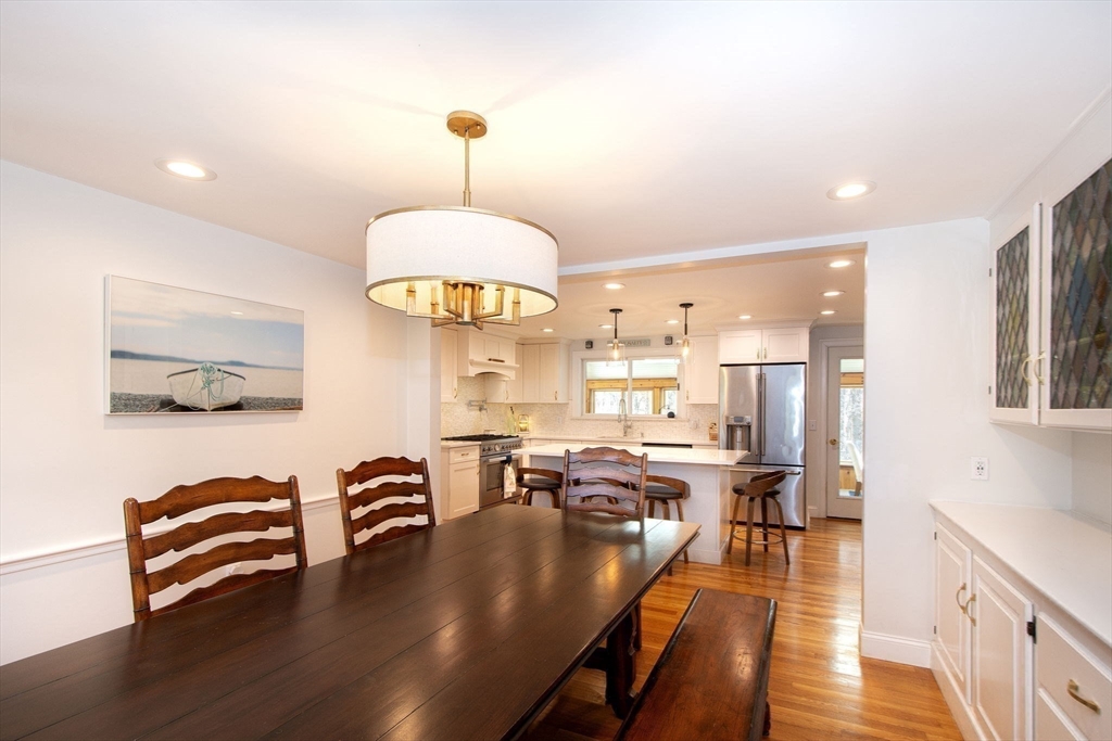 18 Longmeadow Road Scituate, MA 02066 - Photo 12 of 37 a view of a dining room and livingroom with furniture wooden floor a chandelier