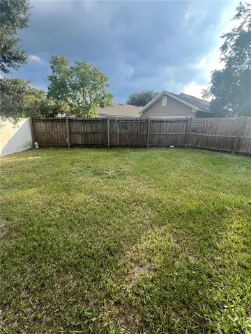 a view of a backyard with table and chairs