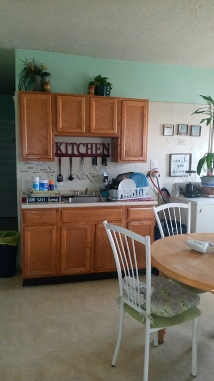 8 Knowlton Avenue Worcester, MA 01603 - Photo 24 of 35 a kitchen with a table chairs sink and cabinets