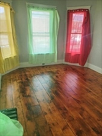 8 Knowlton Avenue Worcester, MA 01603 - Photo 4 of 35 an empty room with wooden floor and windows