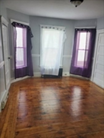 8 Knowlton Avenue Worcester, MA 01603 - Photo 7 of 35 an empty room with wooden floor and windows