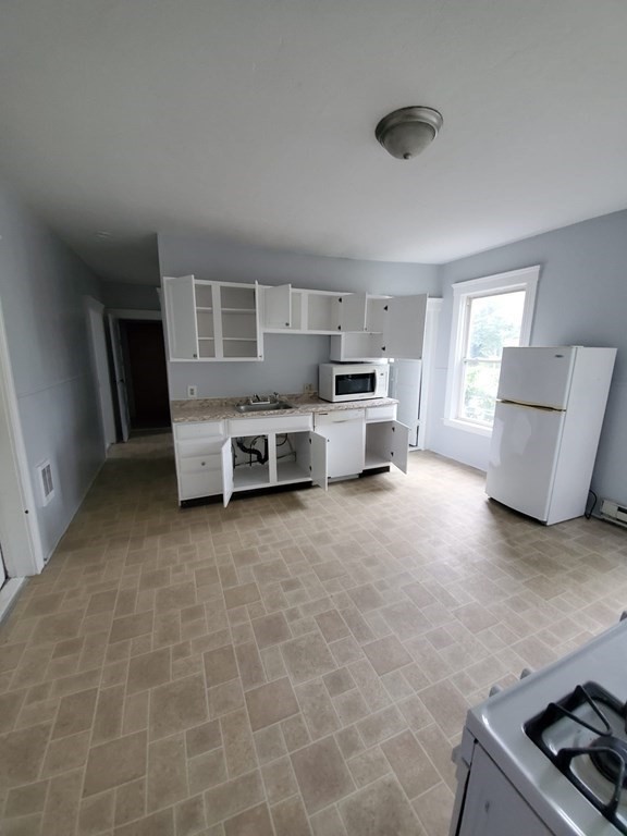 8 Knowlton Avenue Worcester, MA 01603 - Photo 10 of 35 a living room with stainless steel appliances furniture a rug and a window