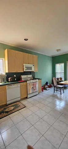 a kitchen with stainless steel appliances a stove a sink and a microwave