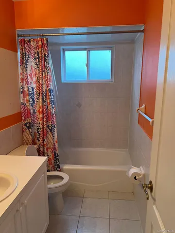a bathroom with a toilet and shower