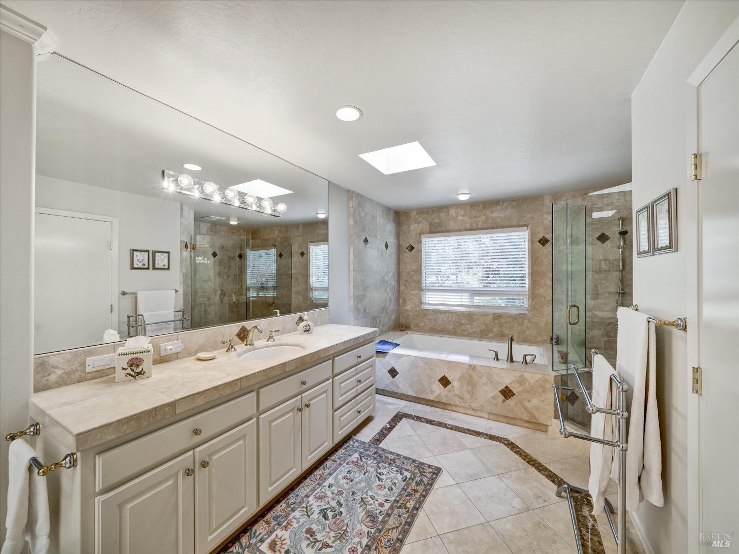 6410 Bennett Valley Road Santa Rosa, CA 95404 - Photo 21 of 34 Very generous dual sided primary bath with large walk-in closet and deep soaking tub.