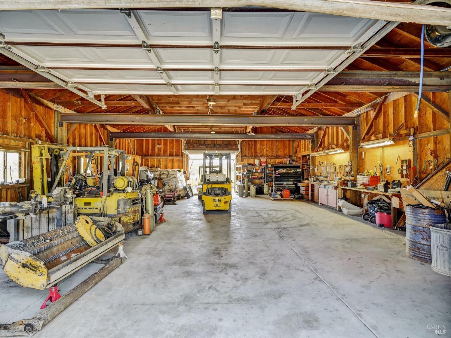 6410 Bennett Valley Road Santa Rosa, CA 95404 - Photo 30 of 34 Barn is steel beamed with concrete floor, drive through doors at each end, full length stand up loft, exterior storage alongside with sliding doors.