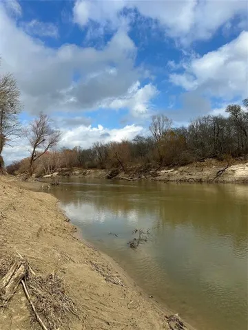 a view of a pathway with a wrought fence