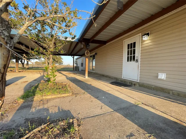 a kitchen with a table chairs refrigerator and microwave