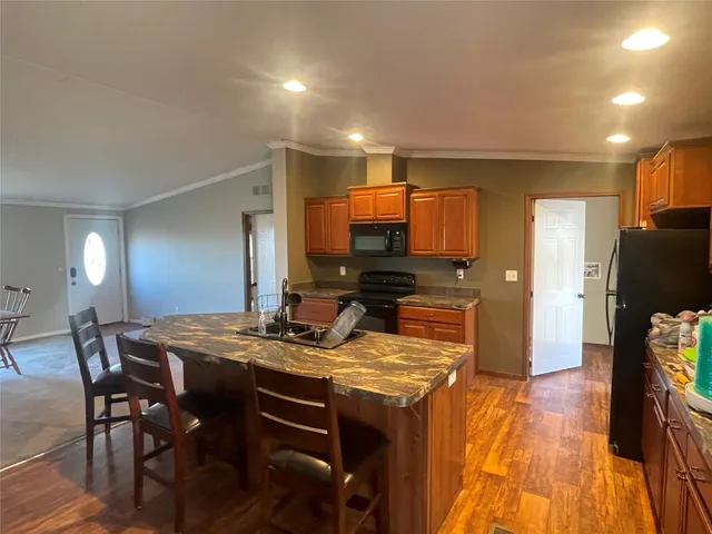 a living room with furniture chandelier and a window