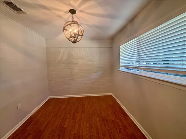 a view of a room with wooden floor and exposed radiator