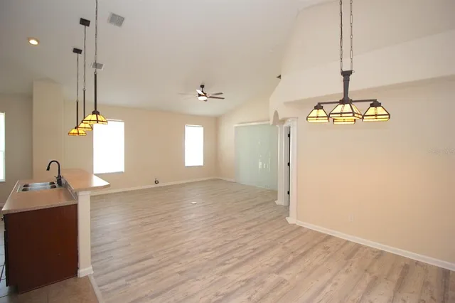 a view of a room with wooden floor